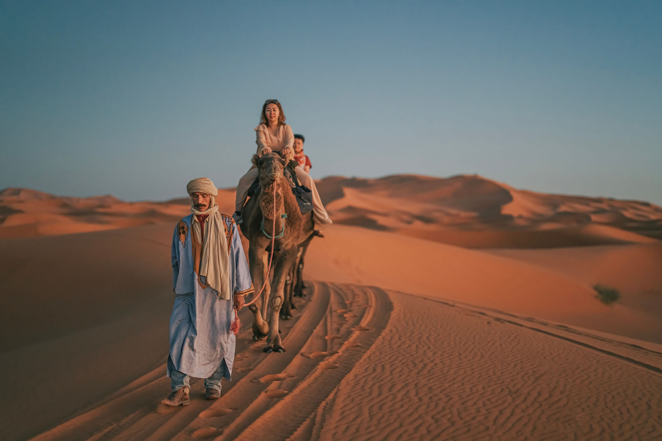 woman riding camel in desert