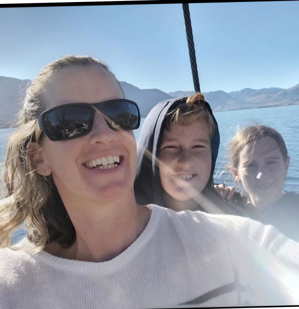 Sequel senior travel advisor Kim with her 2 young children in the back of a boat on a family vacation abroad