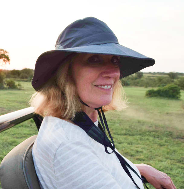 Sequel vacation travel expert enjoying an african safari tour from a tour jeep