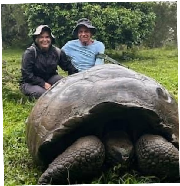 Travel expert Karen bravely poses next to a giant tortoise on an adventurous excursion in the Galapagos