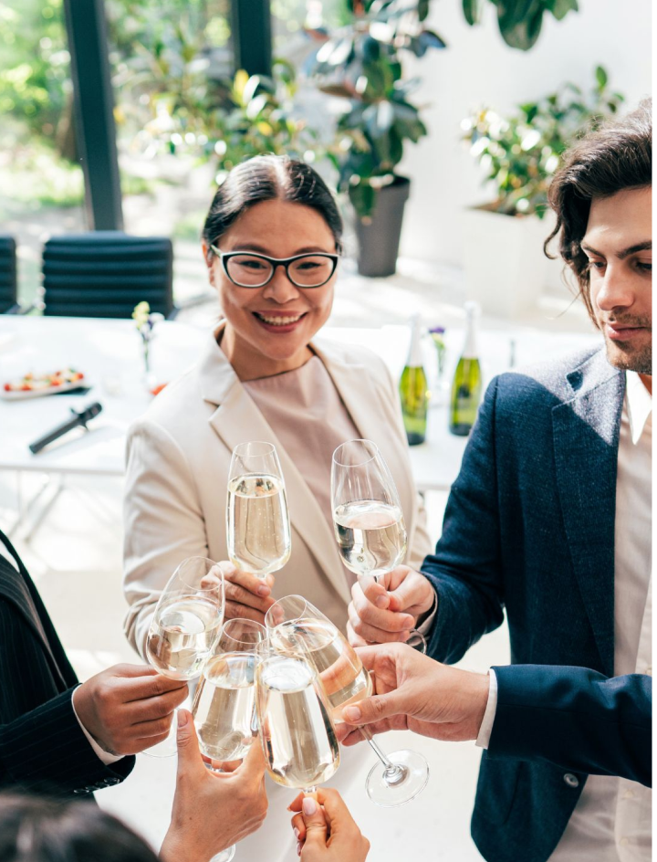 Corporate team enjoying a business lunch with wine tasting during a curated corporate trip