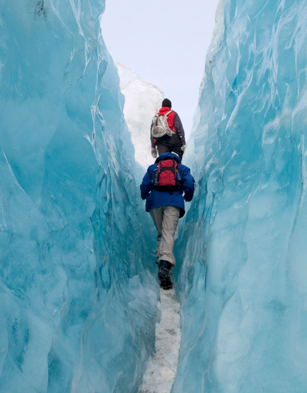 Two people hiking through the Arctic landscape in Argentina on an adventure trip organized by a travel agency