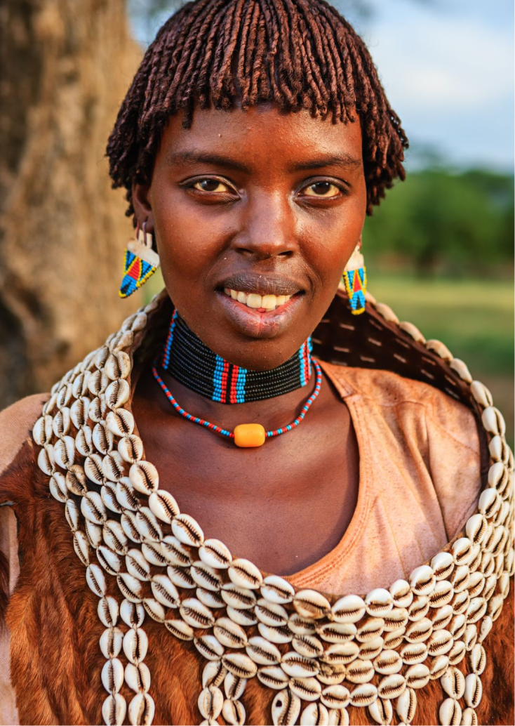 Portrait of a young African woman dressed in traditional African robes and necklaces